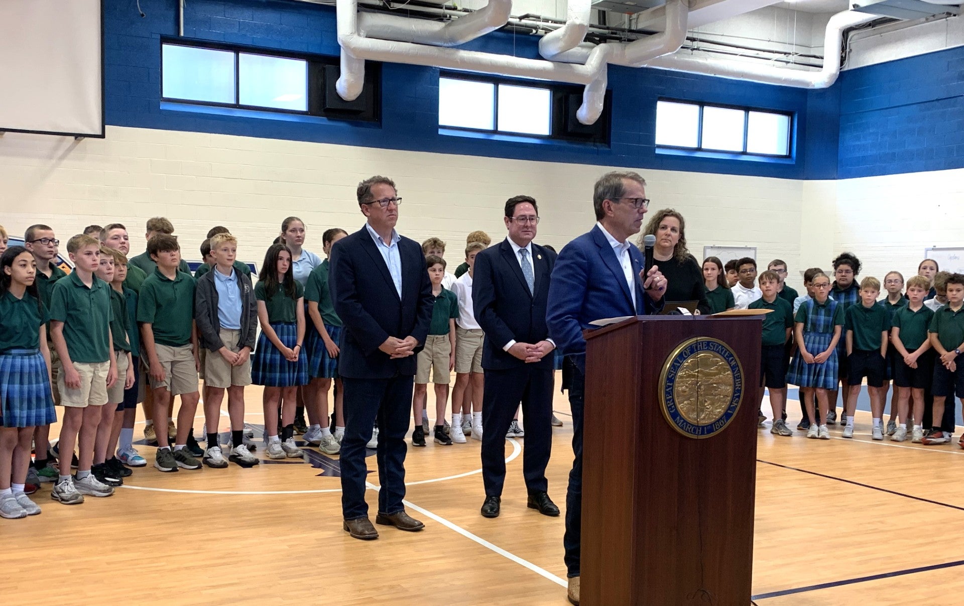 Governor Pillen speaks to the school audience.