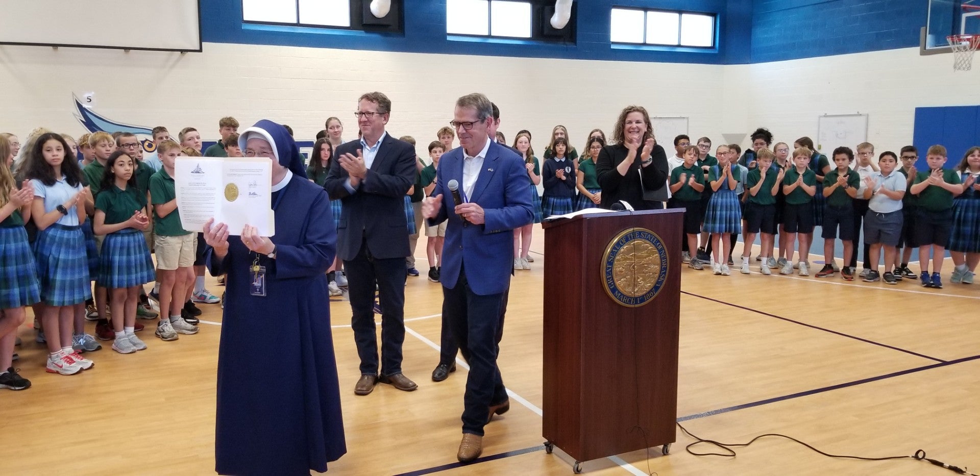 St. Teresa Catholic School Sister displays the signed Executive Order. 