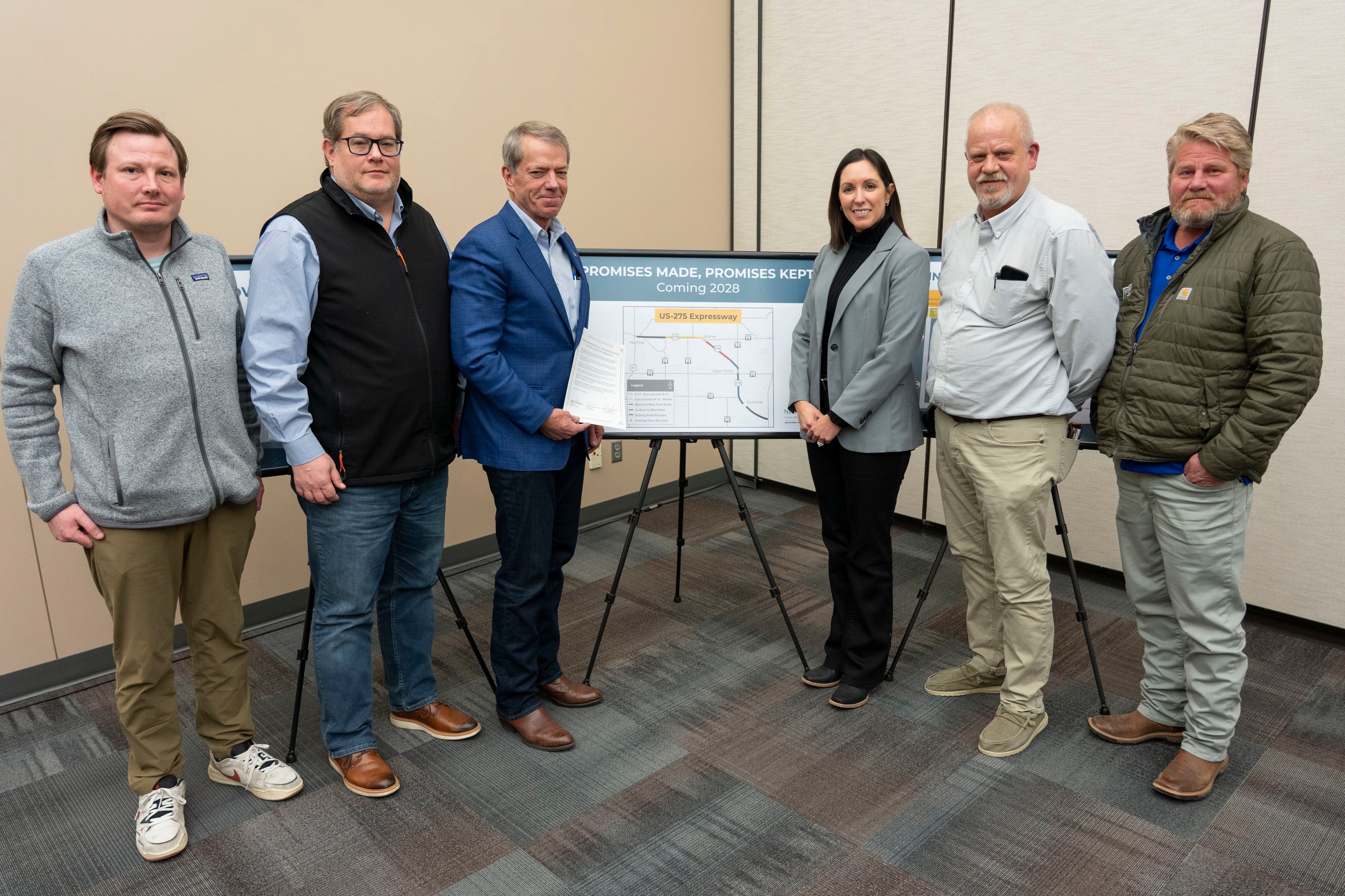 Governor Jim Pillen, NDOT Director Vicki Kramer, and members of the construction crew.