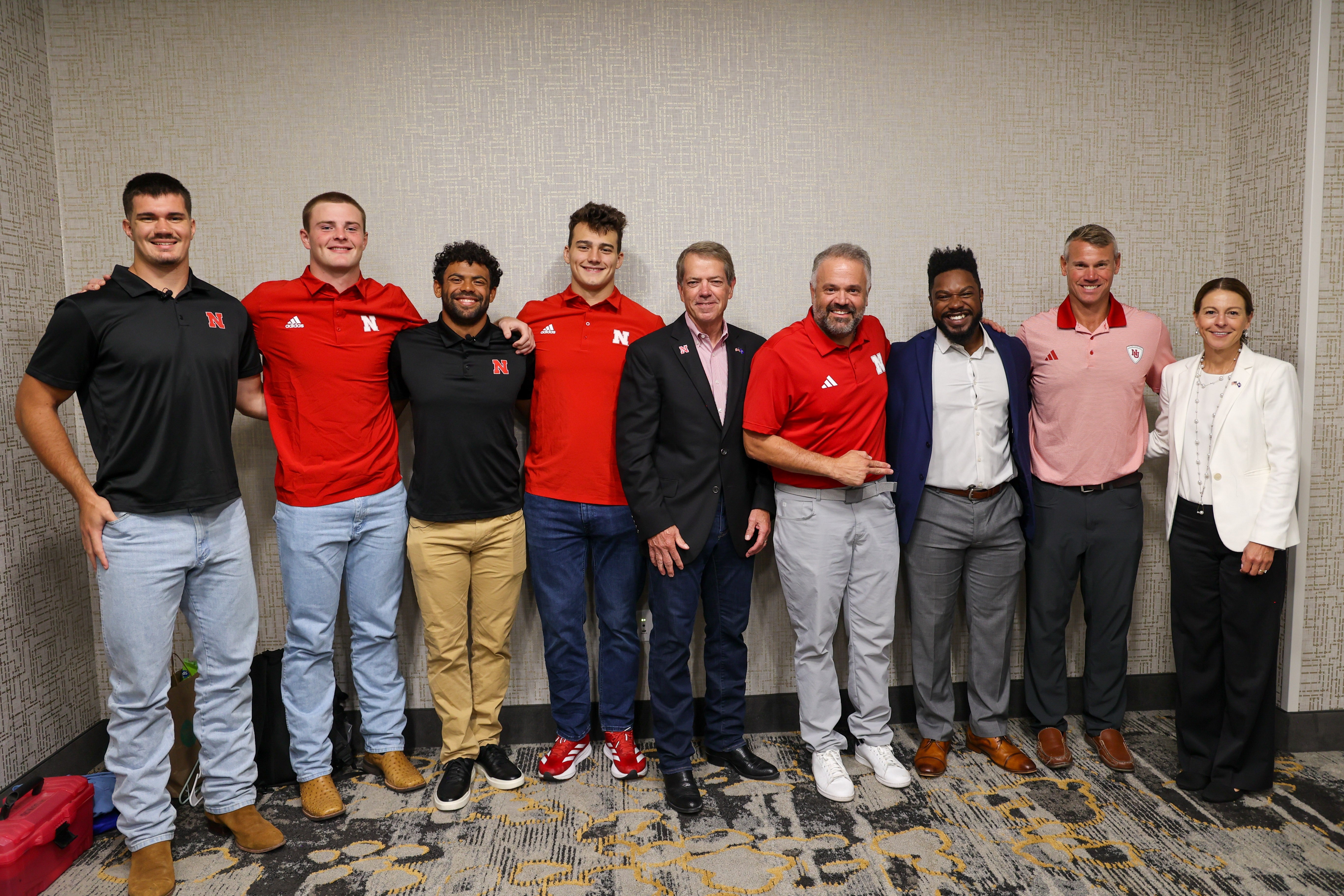 Governor Pillen, Matt Rhule, and current Huskers.