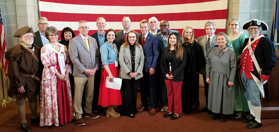 Governor Jim Pillen, First Lady Suzanne, Lieutenant Governor Joe Kelly, members of the Nebraska Semiquincentennial Commission, representatives from the Daughters of the American Revolution (DOR) and the Sons of the American Revolution (SOR), plus event organizers.