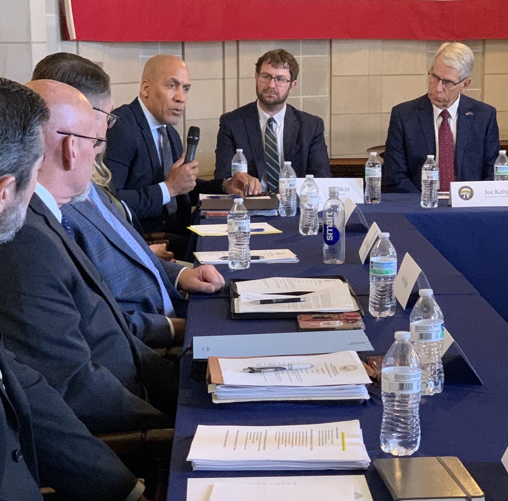 Lee Will, Director Chief Operating Officer Department of Administrative Services and Lt. Governor Joe Kelly, along with other cabinet members listen as Rob Jeffreys, Director Department of Correctional Services speaks.