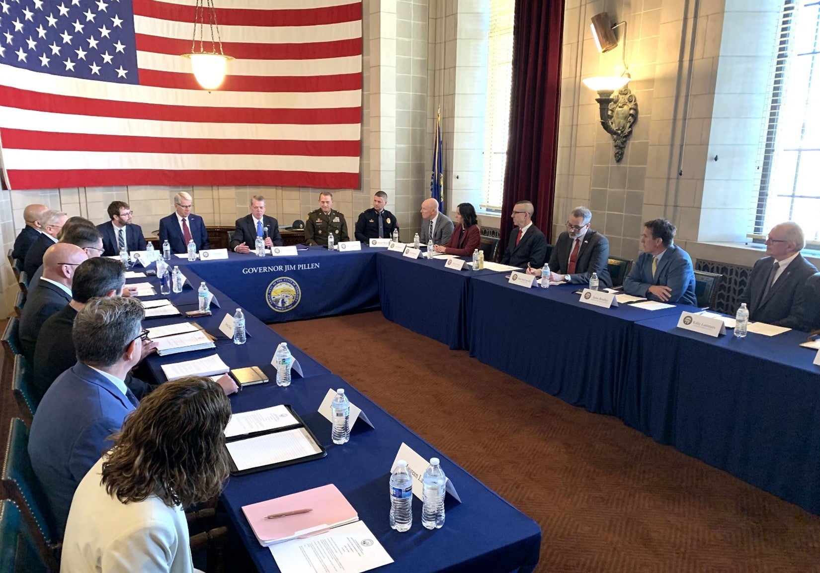 Cabinet members listen as Governor Jim Pillen addresses them.