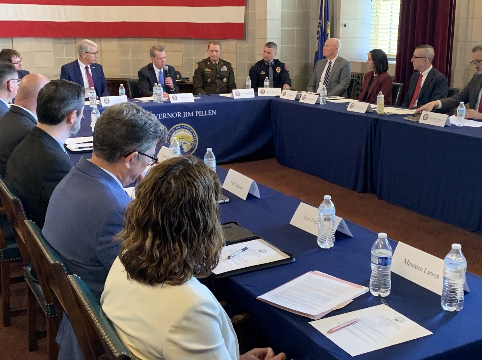 Cabinet members listen as Governor Jim Pillen answers a question.