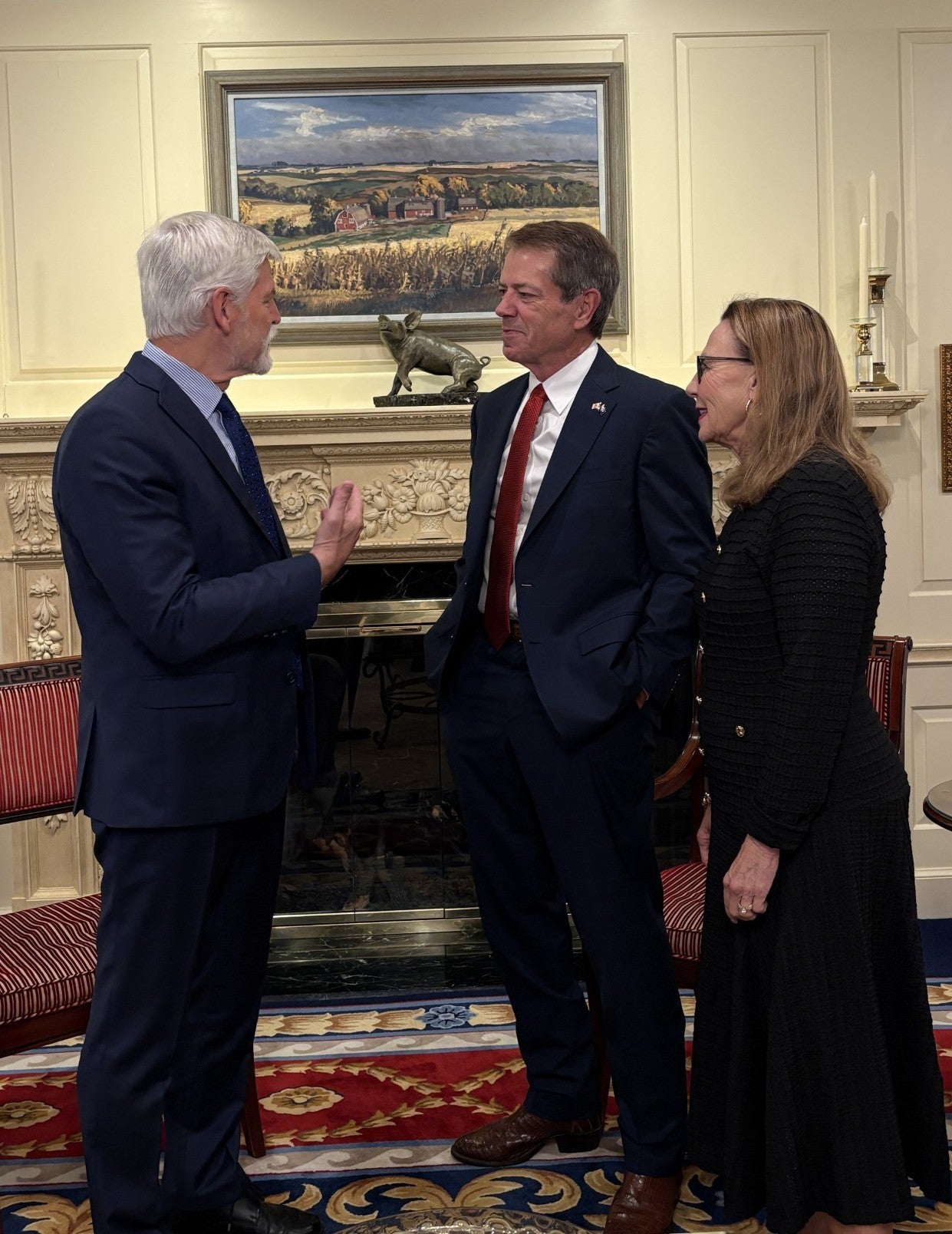 Gov. Jim Pillen and his wife, Suzanne Pillen listen as President Petr Pavel casually speaks with them.