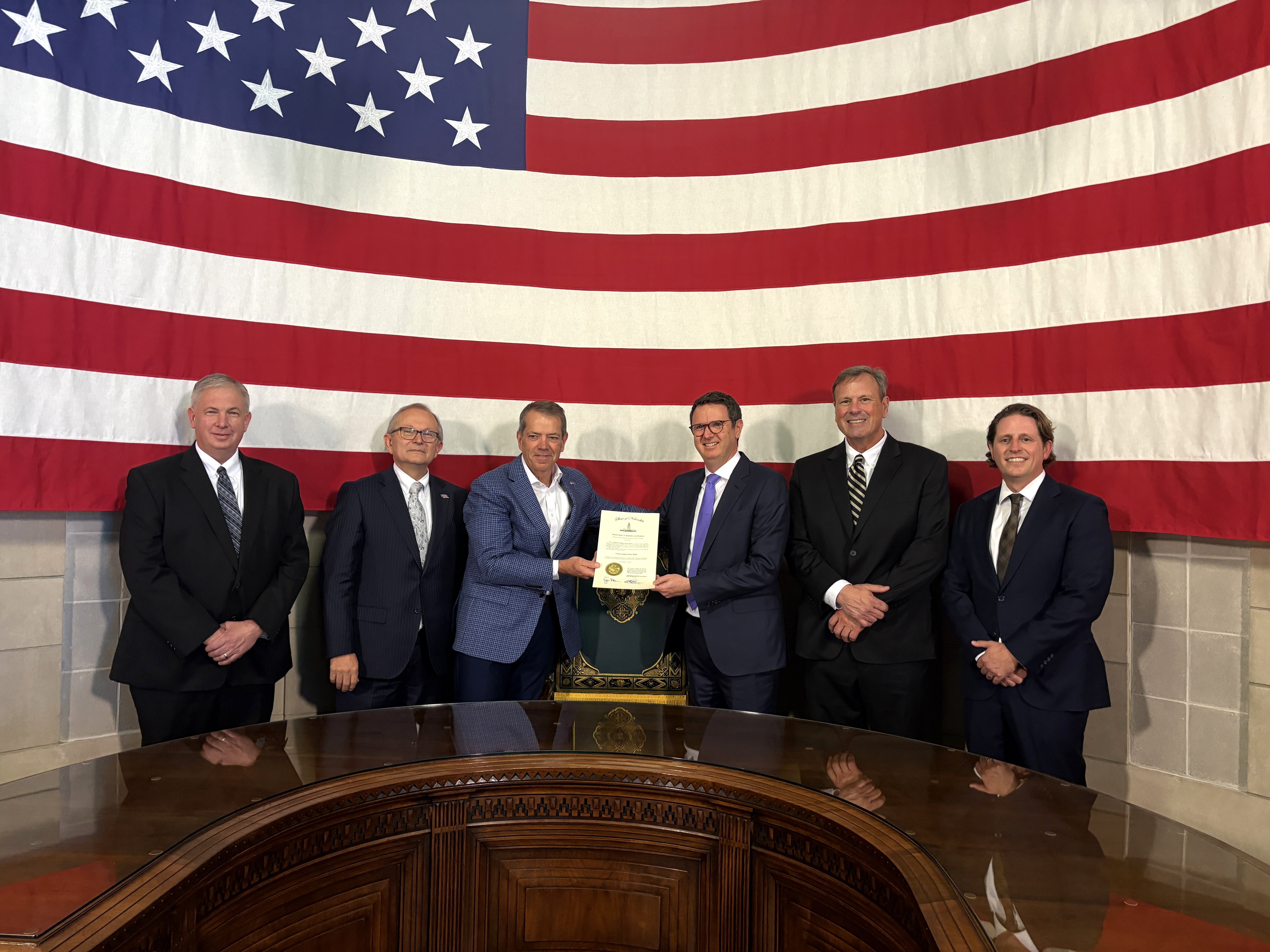Gov. Pillen is joined by Nebraska Department of Banking and Finance Director Kelly Lammers, U.S. Congressman Mike Flood, Paul Neuner, founder and chief executive officer of Telcoin, and other representative at the signing ceremony