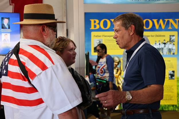Gov. Pillen greets visitors at the Nebraska pavilion