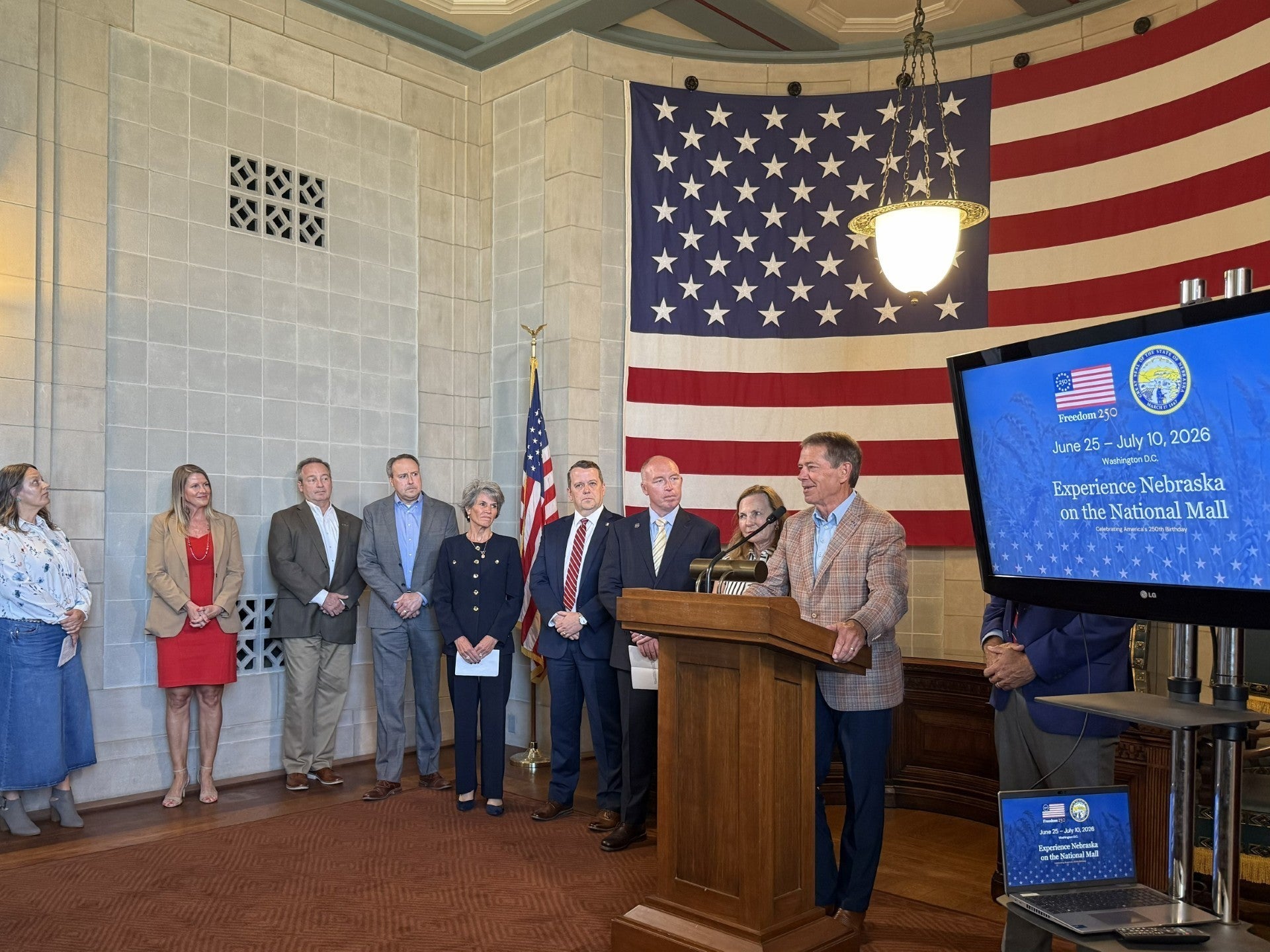 A wide angle shot of Governor Jim Pillen at the presentation, showing the other presenters from various Nebraska institutions.