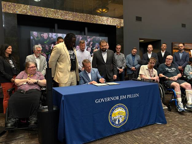 Gov. Pillen signs LB 1091, with Sen. Bostar and QLI CEO Nash Mahupete