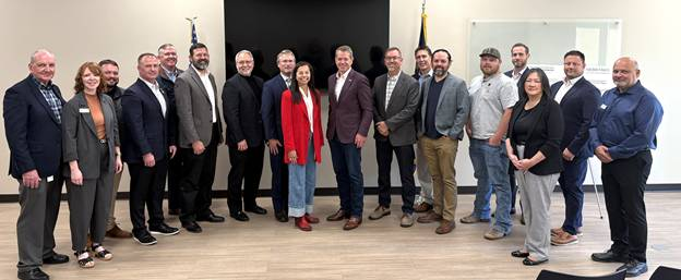 Gov. Pillen, Asst. Sec. Jereza, Director Bradley and Mayor Sookram stand with representatives from public power utilities and news conference attendees