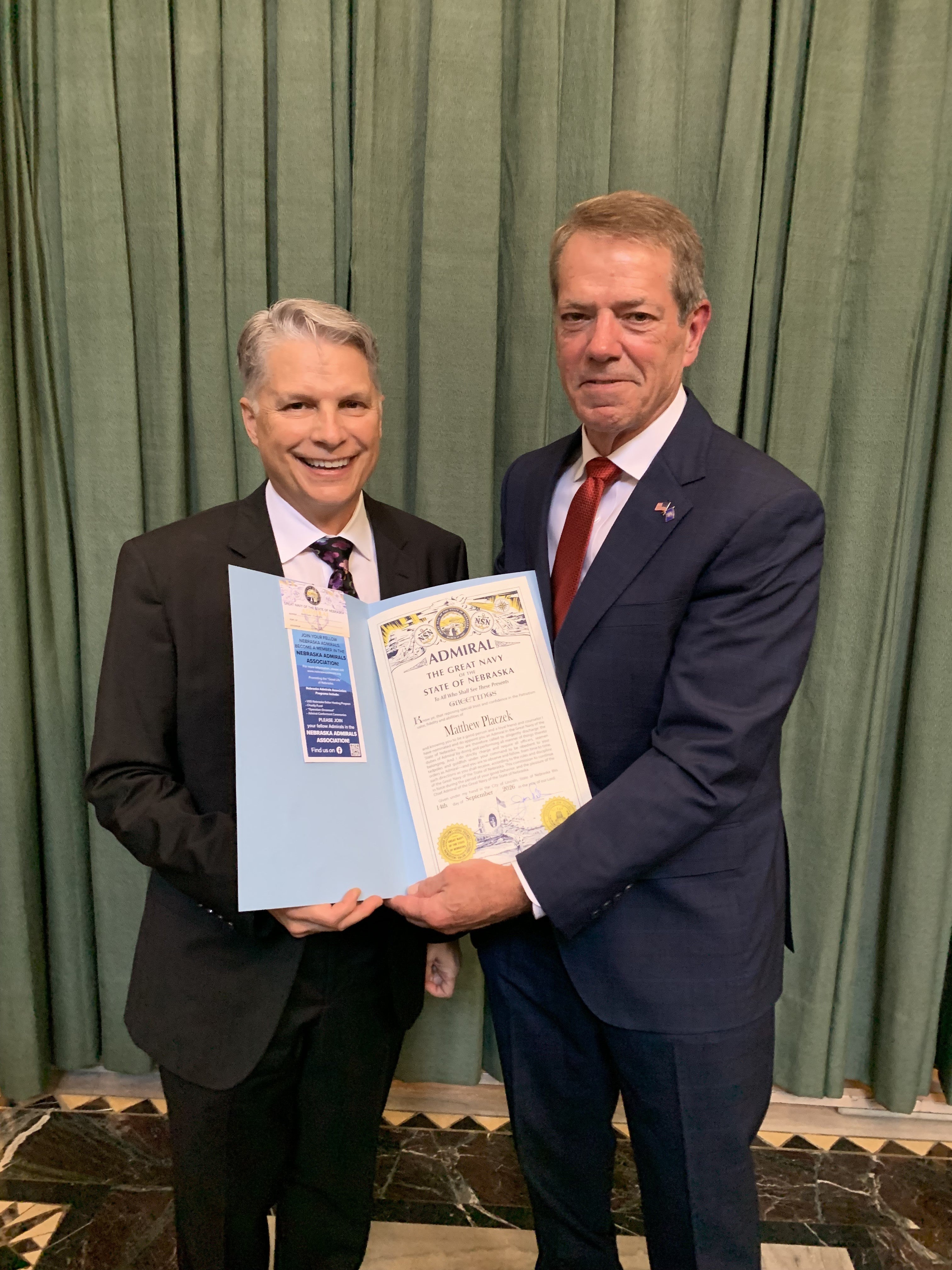 Gov. Pillen presents Nebraska Admiralship to artist Matthew Placzek
