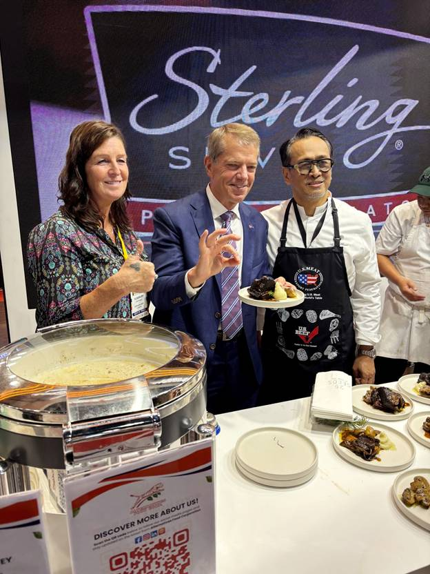 Gov. Pillen and an unnamed member of the Nebraska Beef Council give their approval to food while taking part in a live cooking demonstration at the World Food Expo to provide Filipino customers with a taste of high-quality Nebraska beef.
