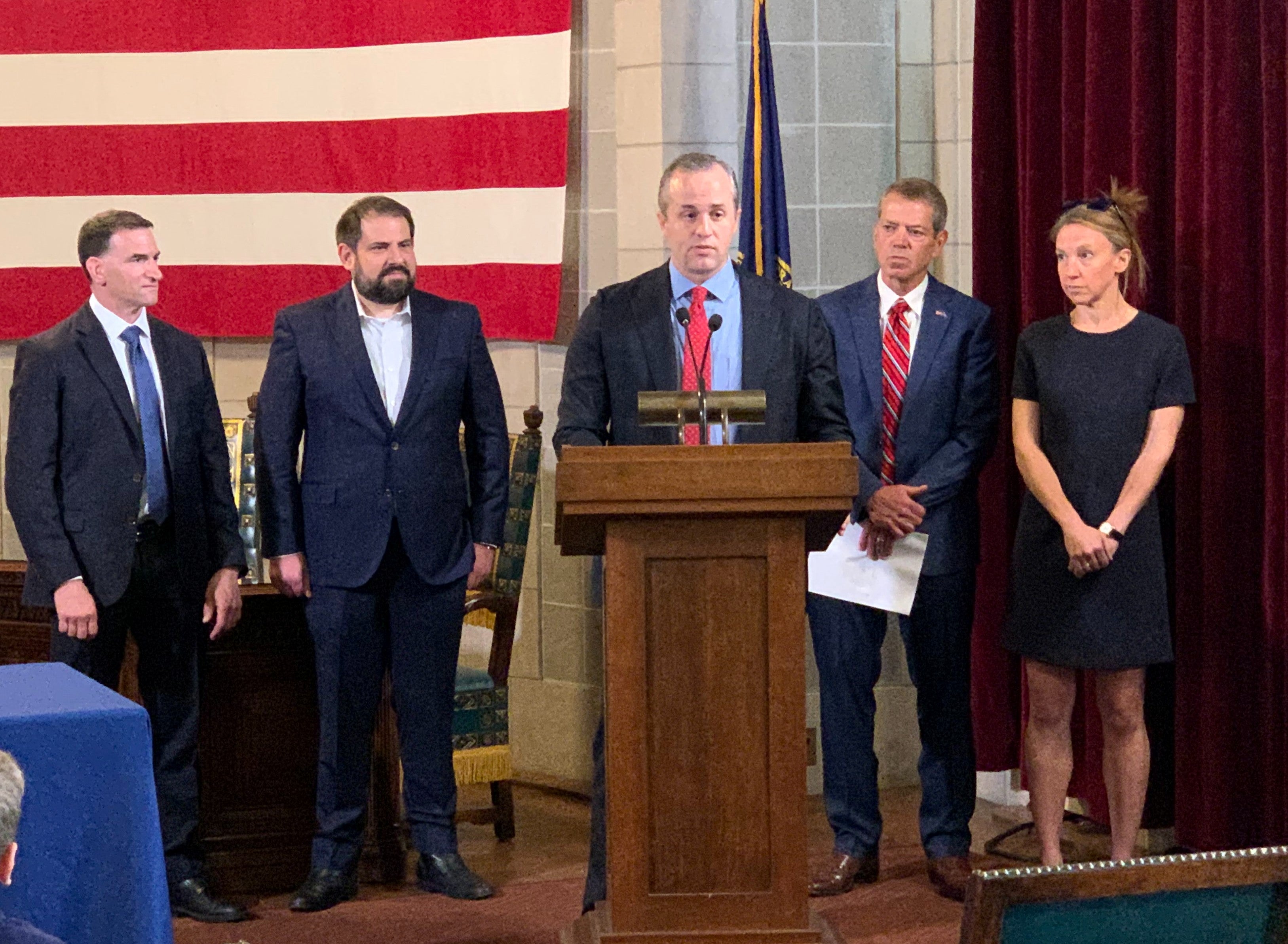 Founder, CEO, and Chairman of State Armor Michael Lucci speaks at the signing of LB 1096. FBI Special Agent Eugene Kowel and Senator Eliot Bostar are to his right, while Governor Jim Pillen and Jackie Deal, with State Armor are to his left.