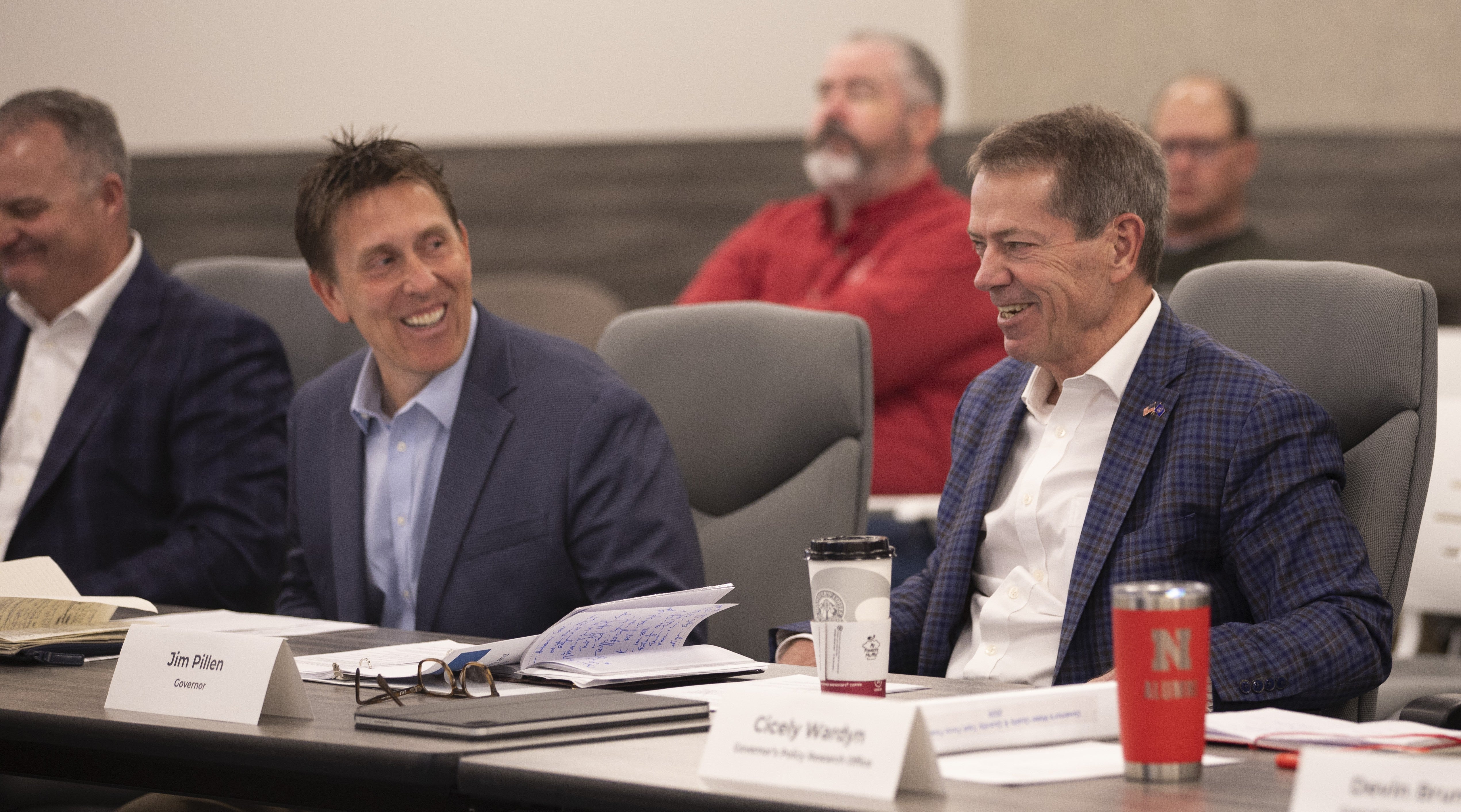 Governor Jim Pillen and Jesse Bradley, Director of the Department of Water, Energy, and Environment, share a laugh during the Water Quality &amp; Quantity Task Force Report meeting.