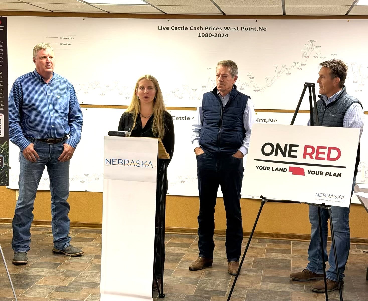 Nebraska Corn Board Director of Innovation and Stewardship Rachael Whitehair addresses the audience. She is joined by Scott Knobbe, Governor Jim Pillen, and Nebraska Department of Water, Energy, and Environment (DWEE) Director Jesse Bradley.
