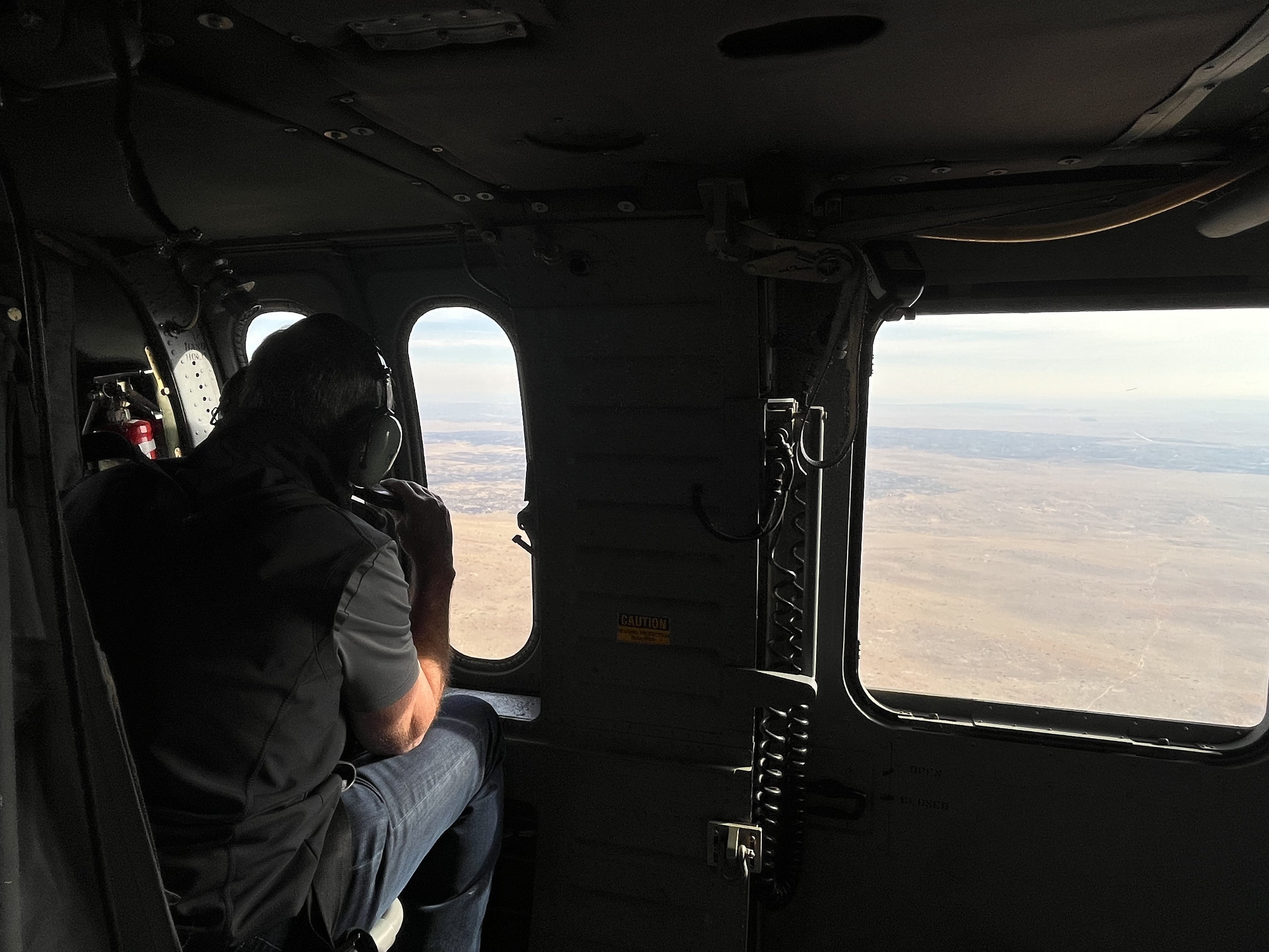 Governor Pillen's view of the land looking out a National Guard helicopter.