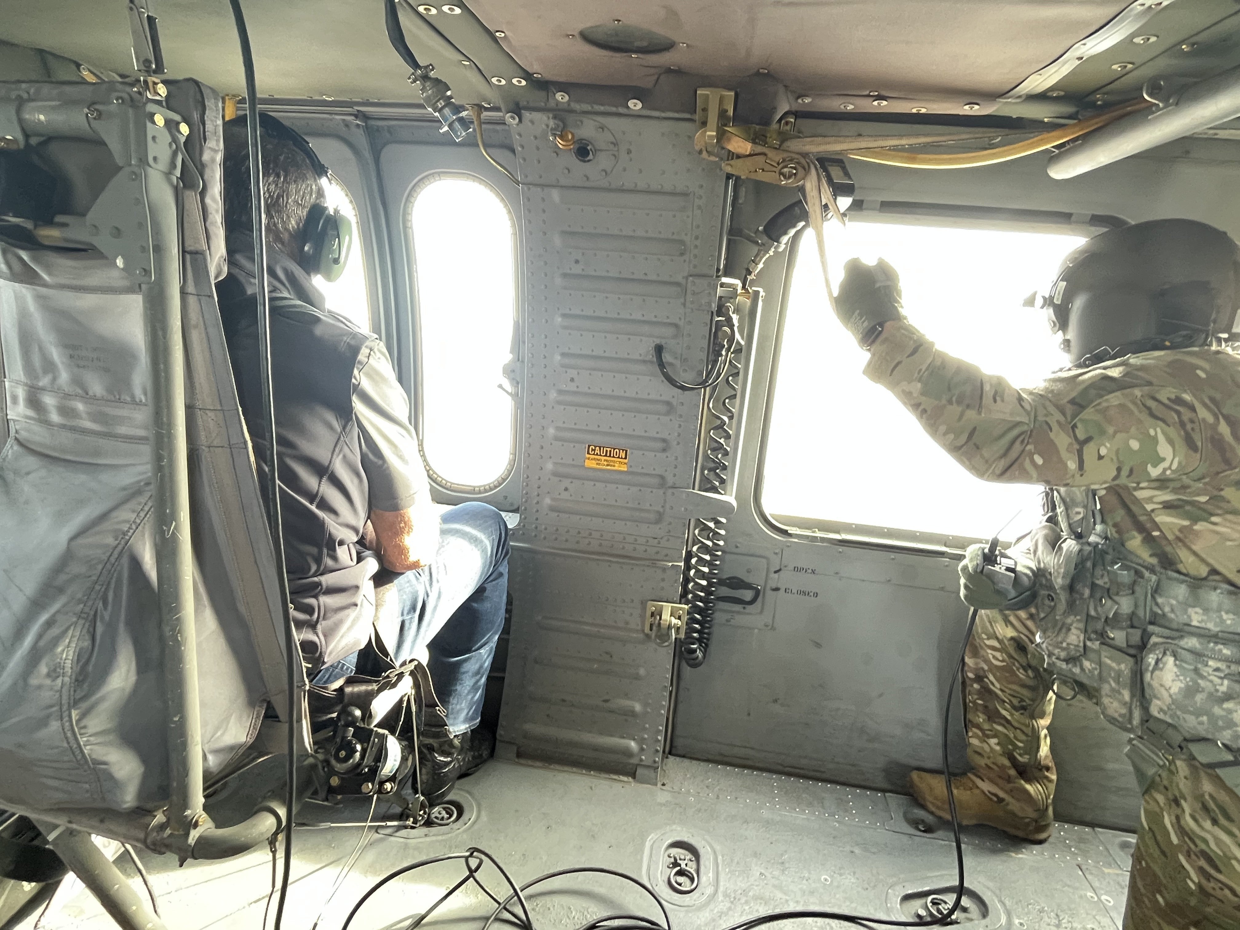Governor Pillen and a National Guard serviceman view the wildfires from a National Guard helicopter.