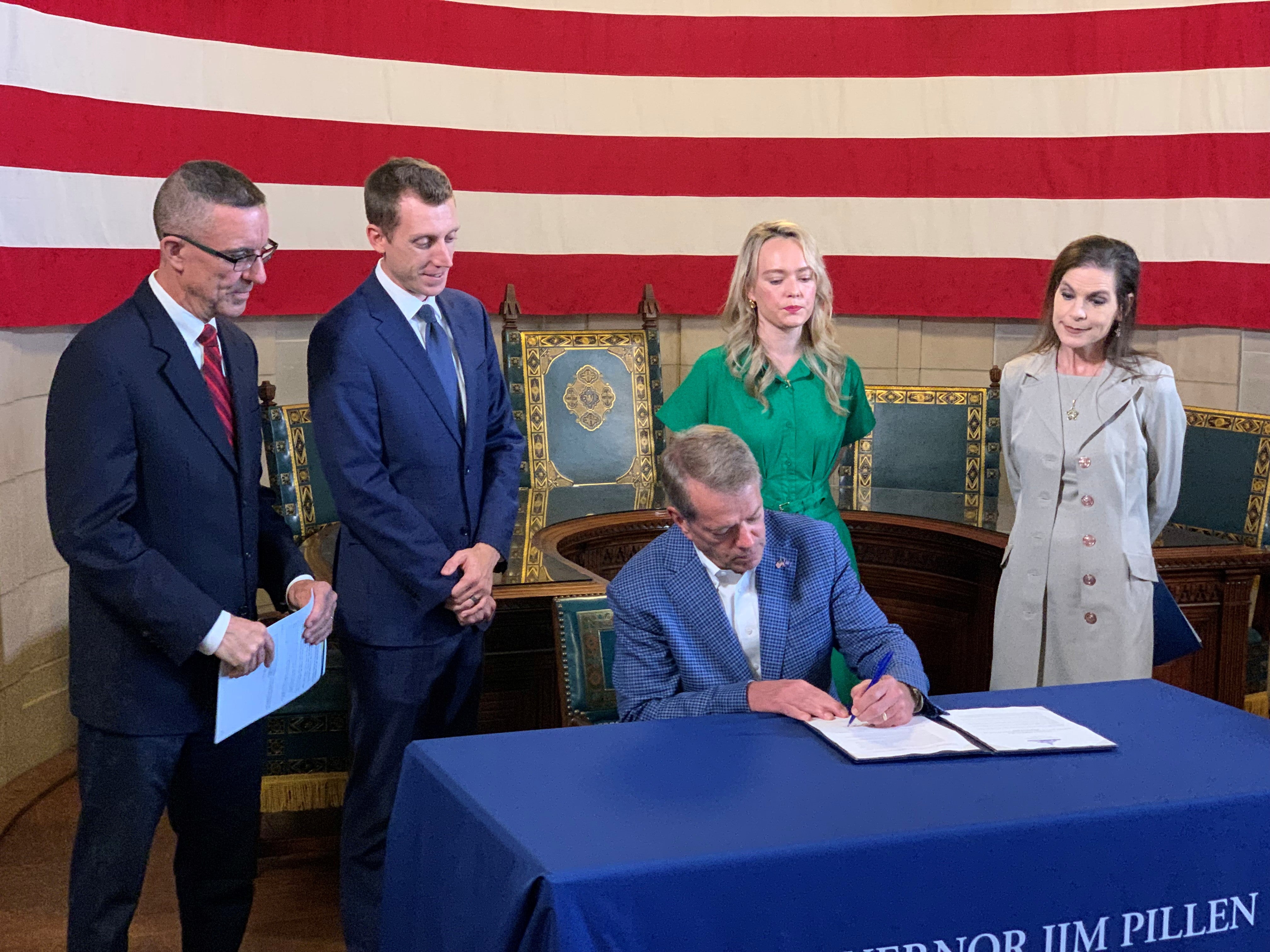 Governor Jim Pillen signs the Executive Order for TANF funds restrictions. He is surrounded by Dr. Steve Corsi, MiMi Greene, and Barbara Lacina.
